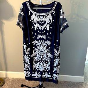 Navy blue dress with embroidered detail on the front and sleeves.